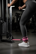 Ankle strap on person at cable machine